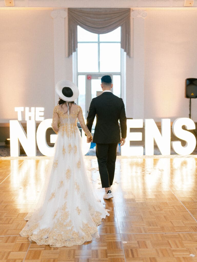 Bride and groom wearing traditional Vietnamese wedding attire during their reception