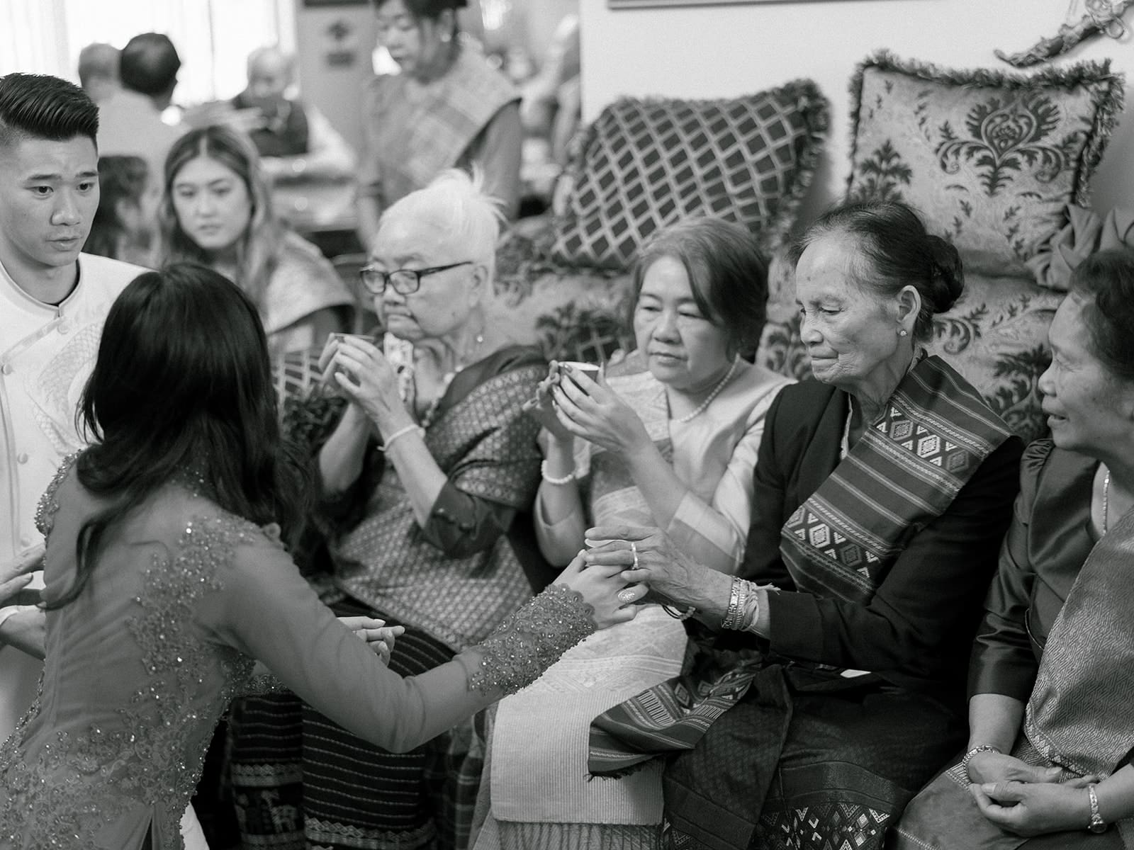 Bride and grooms tea ceremony during their at home Lao and Vietnamese wedding ceremony in Indiana