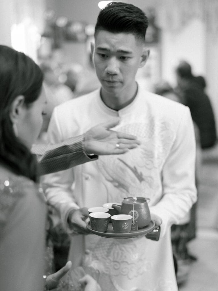 Bride and grooms tea ceremony during their at home Lao and Vietnamese wedding ceremony in Indiana
