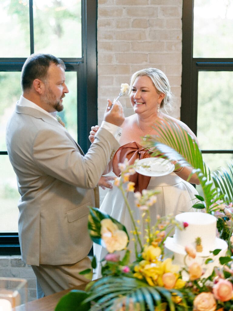 Bride and groom cutting into their wedding cake 