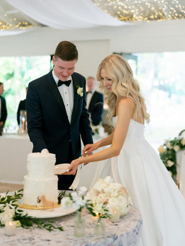 Bride and groom cutting their two tiered wedding cake