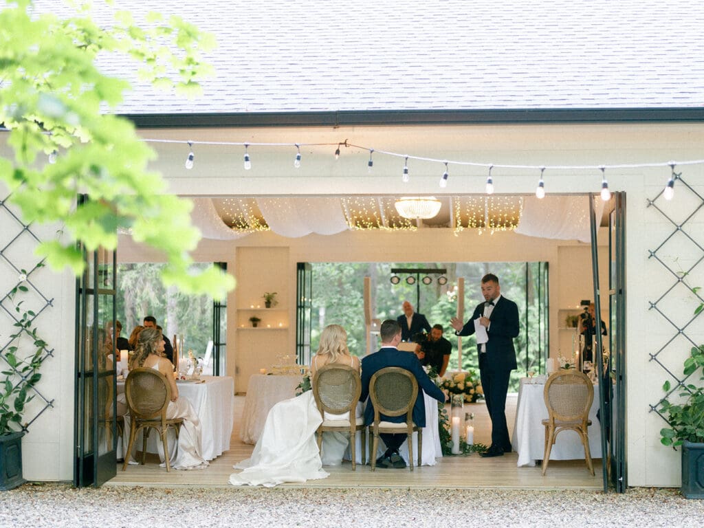 Bride and groom listening to speeches during their wedding reception