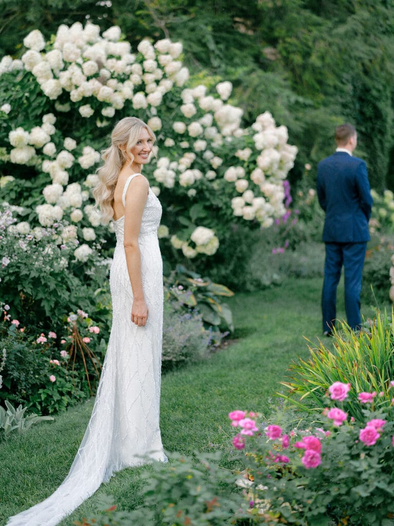 Bride and grooms "second look" during the brides wedding reception dress change in the gardens of Greencrest Manor wedding venue in Battle Creek, Michigan