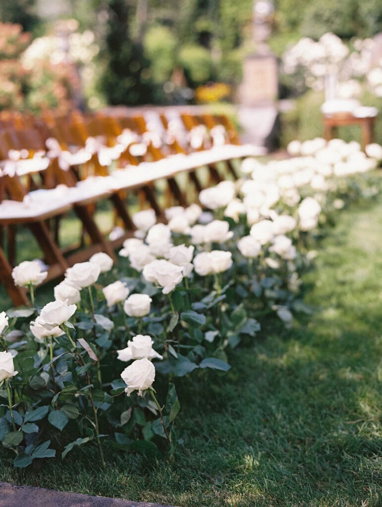 Greencrest Manor wedding ceremony set up with white roses lining the aisle