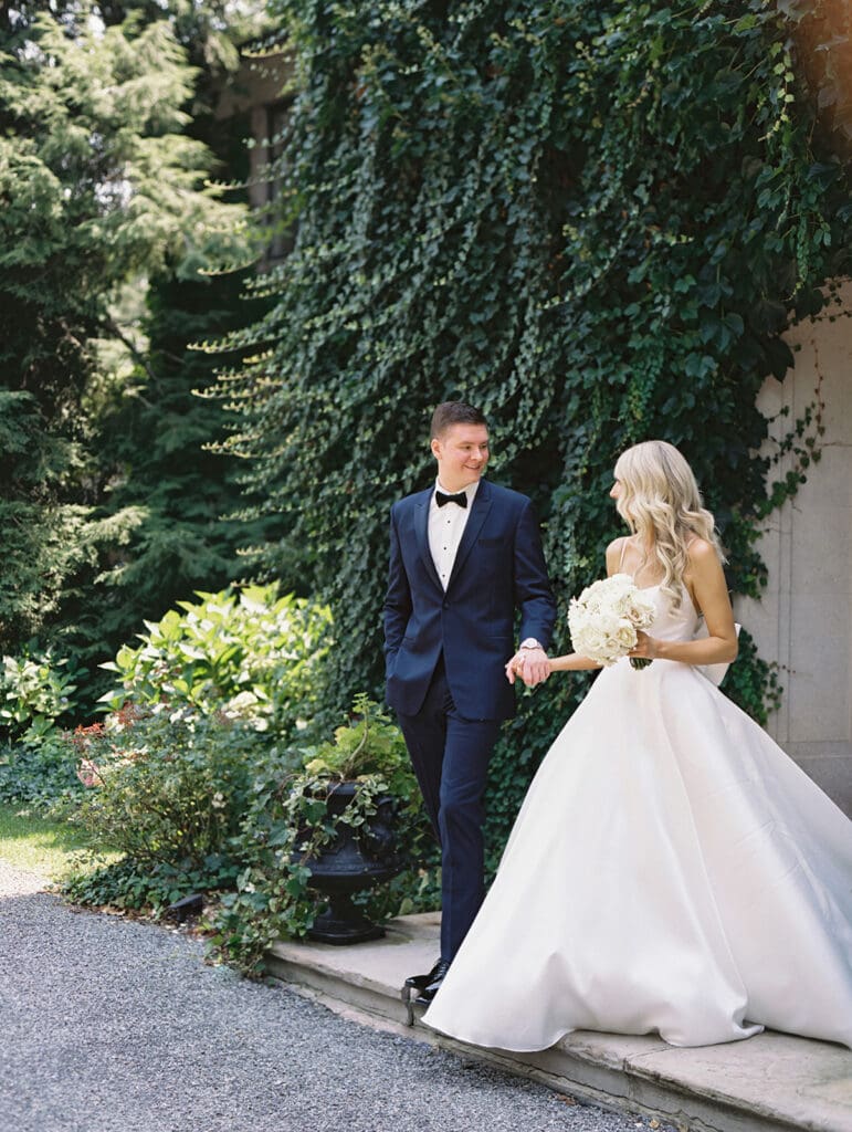 Bride and groom walking outside of Greencrest Manor wedding venue in Battle Creek, Michigan