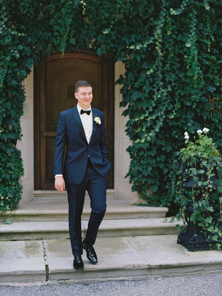 Outdoor grooms portraits in front of Greencrest Manor wedding venue in Battle Creek, Michigan