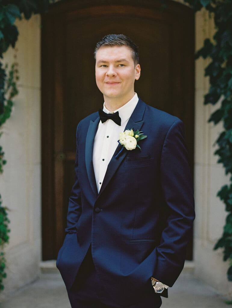 Outdoor grooms portraits in front of Greencrest Manor wedding venue in Battle Creek, Michigan