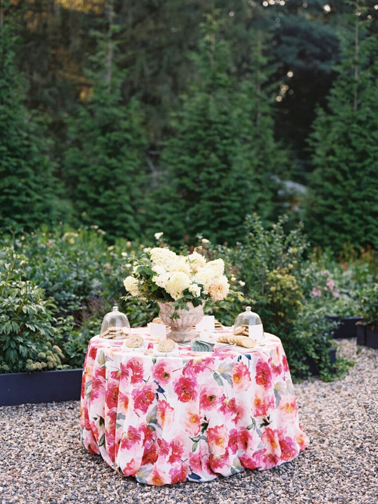 Small welcome wedding party desert table with florals and cookies
