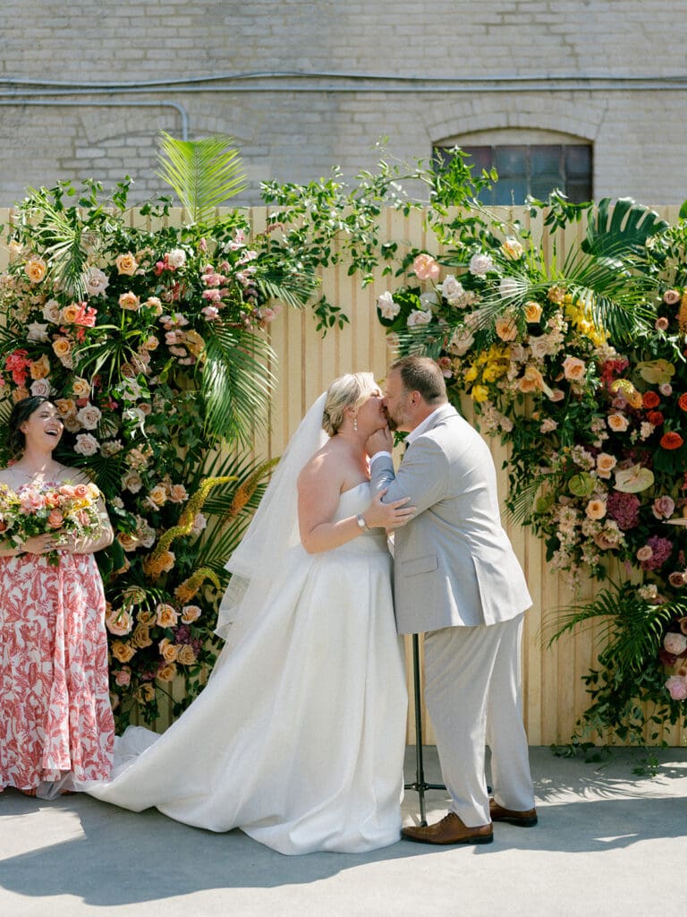 Bride and groom kissing during their Journeyman Distillery wedding ceremony in Three Oaks, Michigan