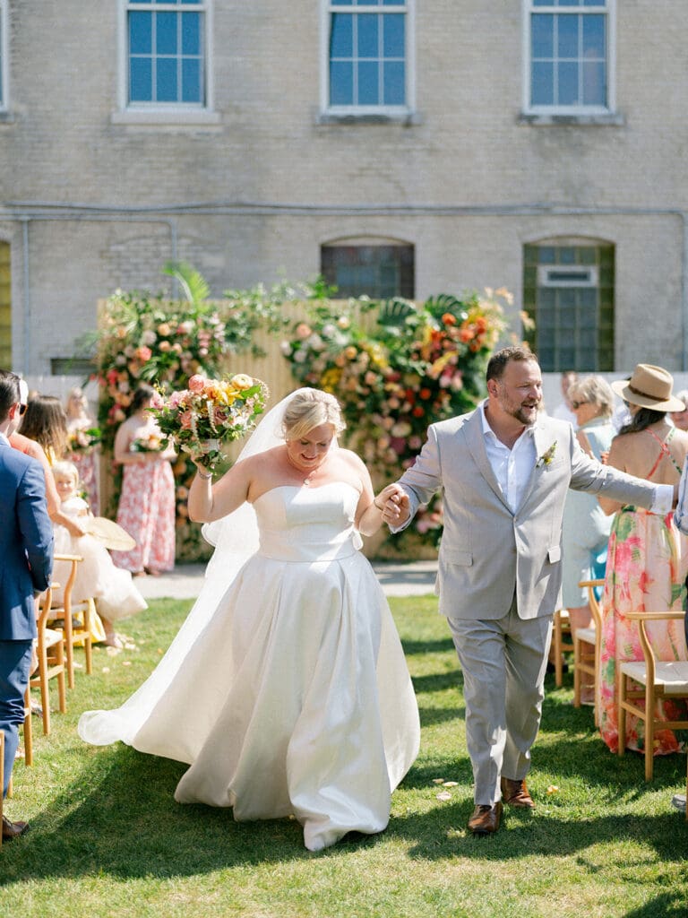 Bride and groom walking back down the aisle together after their Journeyman Distillery wedding ceremony