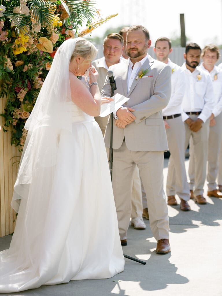 Bride getting emotional as she reads her vows to her groom during their Journeyman Distillery wedding ceremony in Three Oaks, Michigan