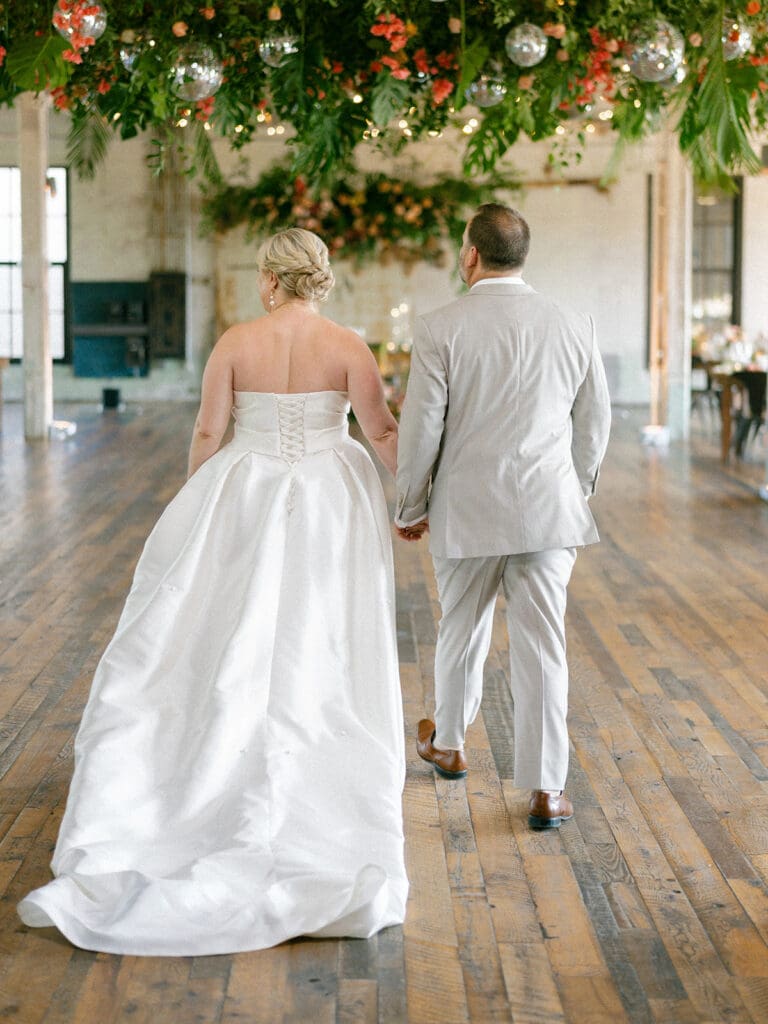 Bride and groom wedding reception room reveal at Journeyman Distillery wedding venue in Three Oaks, Michigan