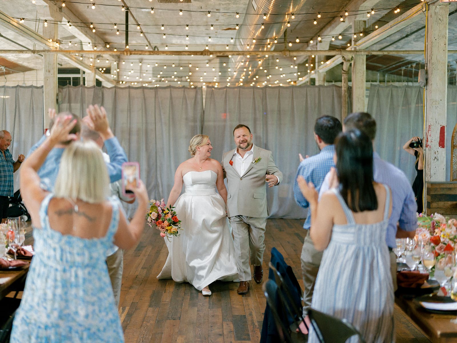 Bride and groom entering their Journeyman Distillery wedding reception in Three Oaks, Michigan