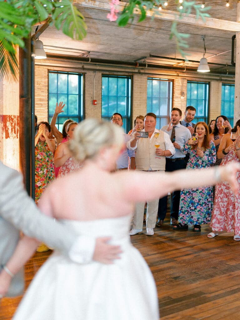 Bride and groom after their first dance as their guests clap for them