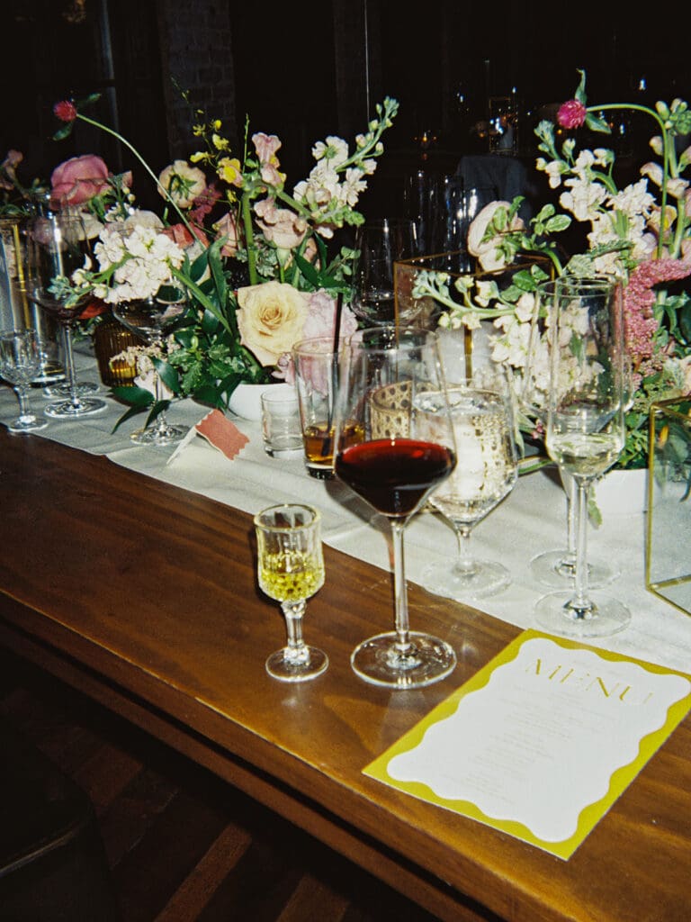 Flash photo of a messy wedding reception table at the end of the night captured on film