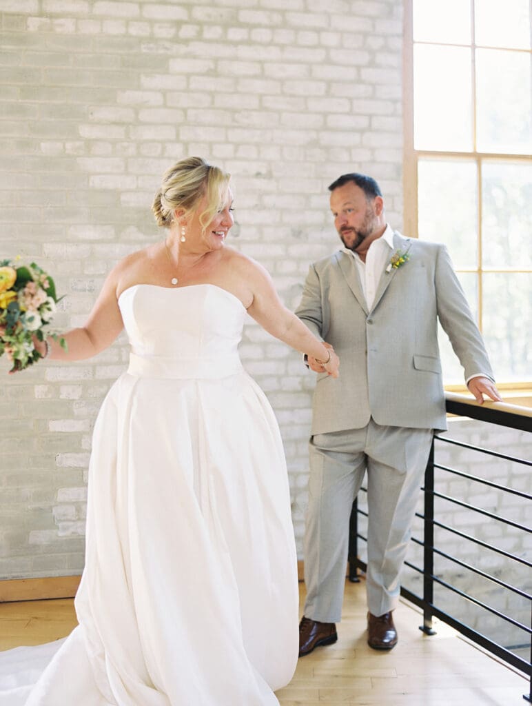 Bride and groom sharing a first look at Journeyman Distillery wedding venue in Three Oaks, Michigan