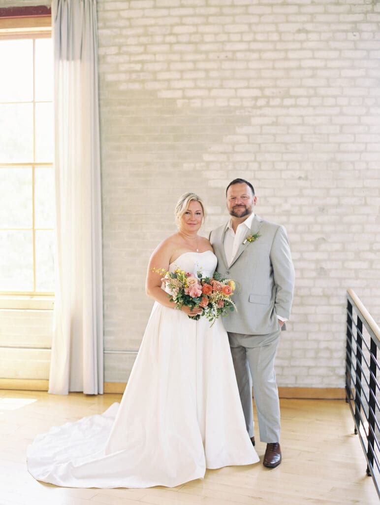 Indoor bride and grooms portraits from their colorful summer Journeyman Distillery wedding in Three Oaks, Michigan