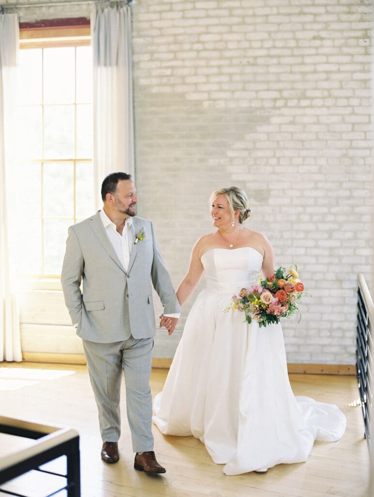 Bride and groom kissing during their wedding portraits at Journeyman Distillery wedding venue in Three Oaks, Michigan