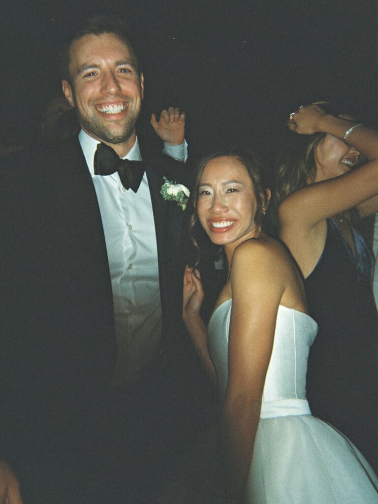 Film wedding reception photos of a bride and groom dancing