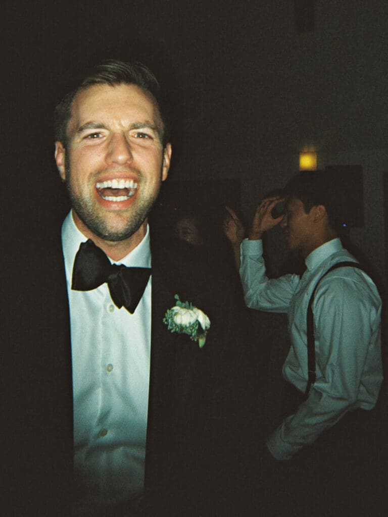 Groom laughing during the reception captured on film