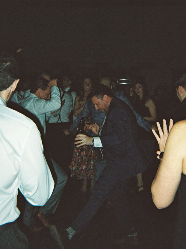 Wedding guests dancing during the reception captured on film