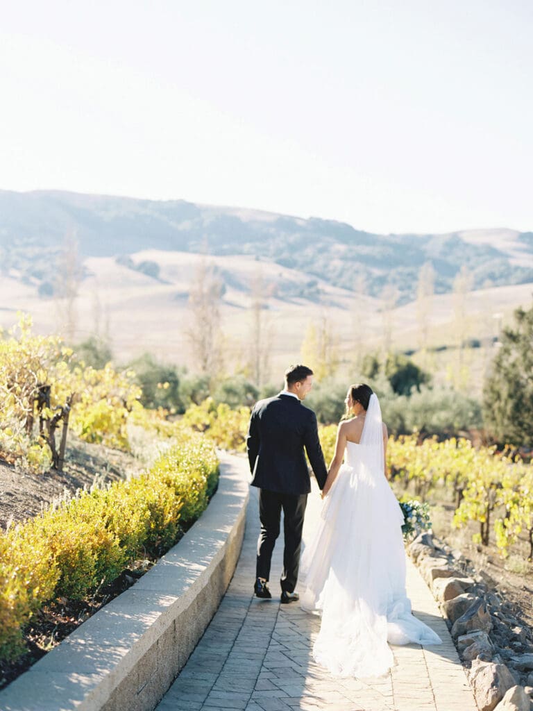 Bride and grooms walking the property at Viansa Winery wedding venue in Sonoma, California