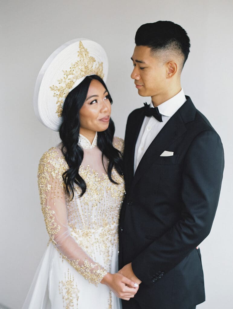 Bride and groom's studio portraits in South Bend, Indiana wearing traditional Vietnamese wedding attire. 