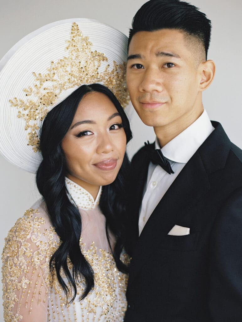 Bride and groom's studio portraits in South Bend, Indiana wearing traditional Vietnamese wedding attire. 