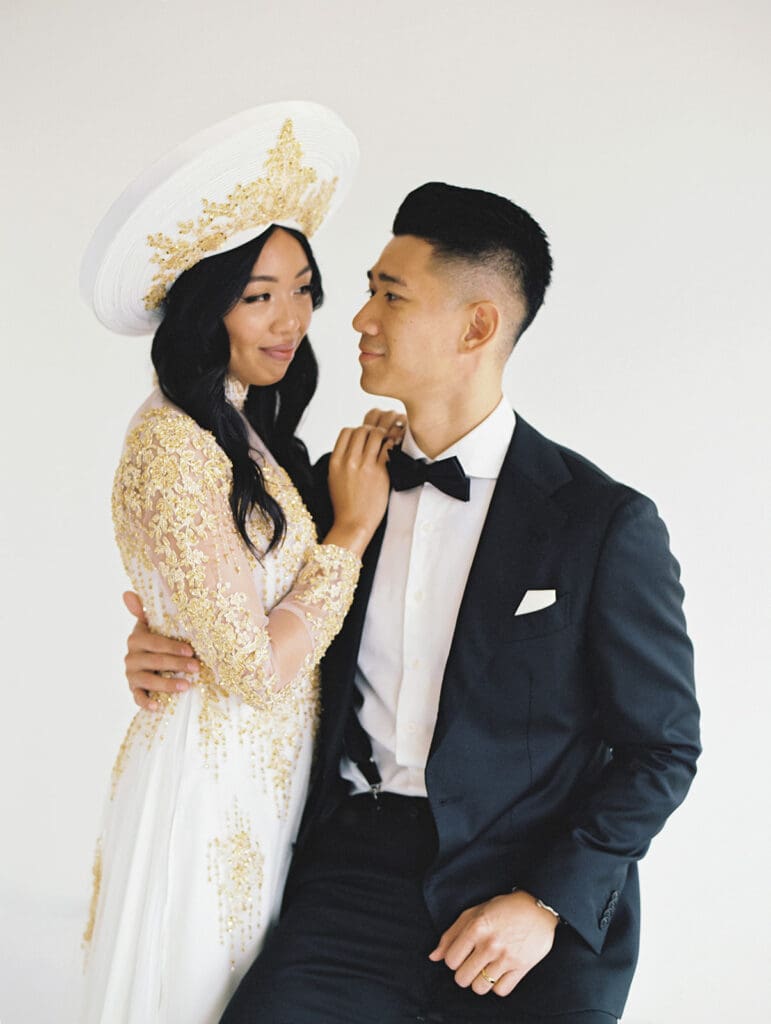 Bride and groom's studio portraits in South Bend, Indiana wearing traditional Vietnamese wedding attire. 