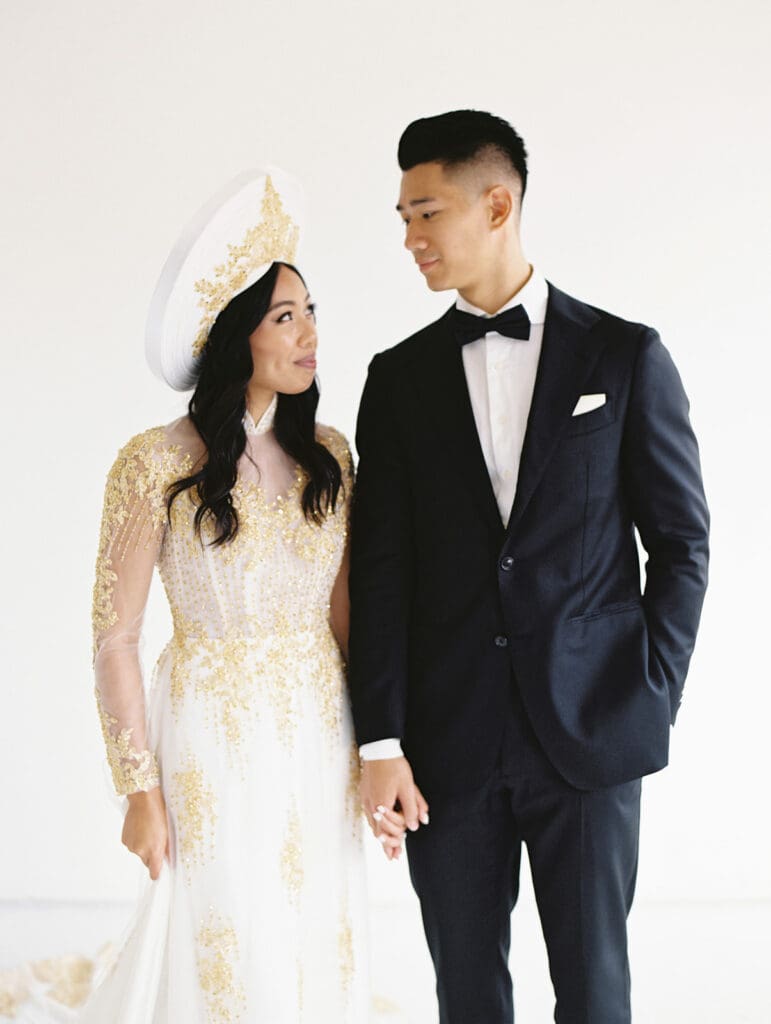 Bride and groom's studio portraits in South Bend, Indiana wearing traditional Vietnamese wedding attire. 