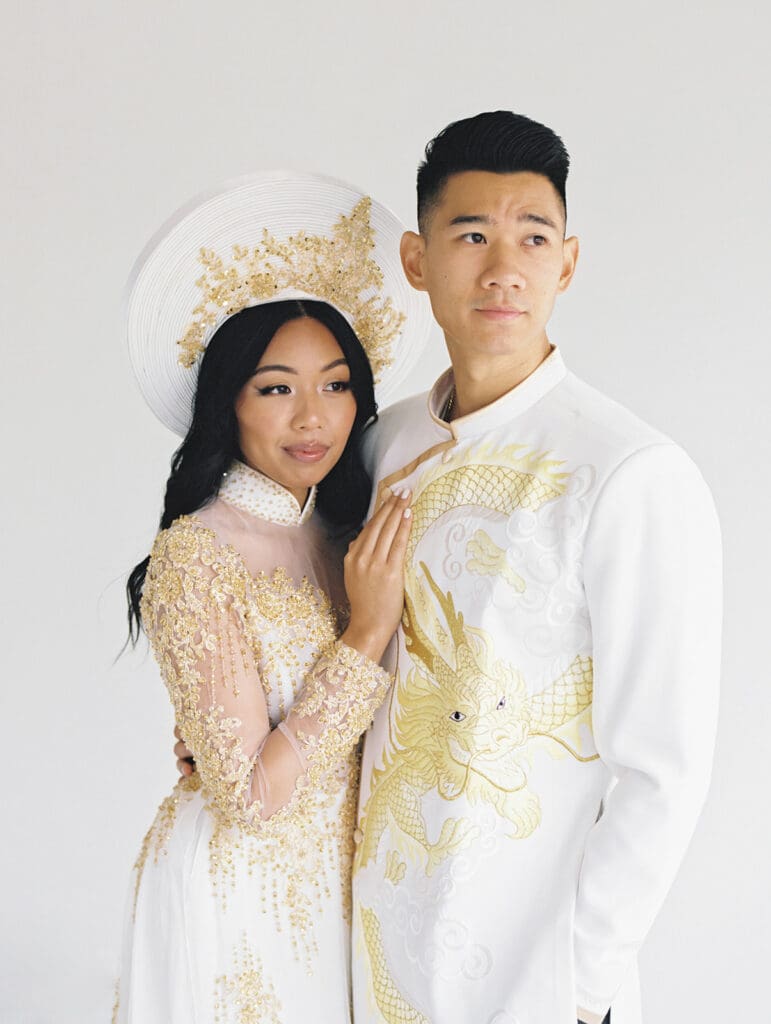Bride and groom's studio portraits in South Bend, Indiana wearing traditional Vietnamese wedding attire. 