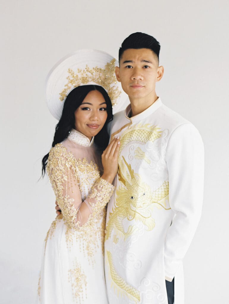 Bride and groom's studio portraits in South Bend, Indiana wearing traditional Vietnamese wedding attire. 