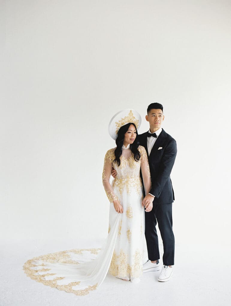 Bride and groom's studio portraits in South Bend, Indiana wearing traditional Vietnamese wedding attire. 