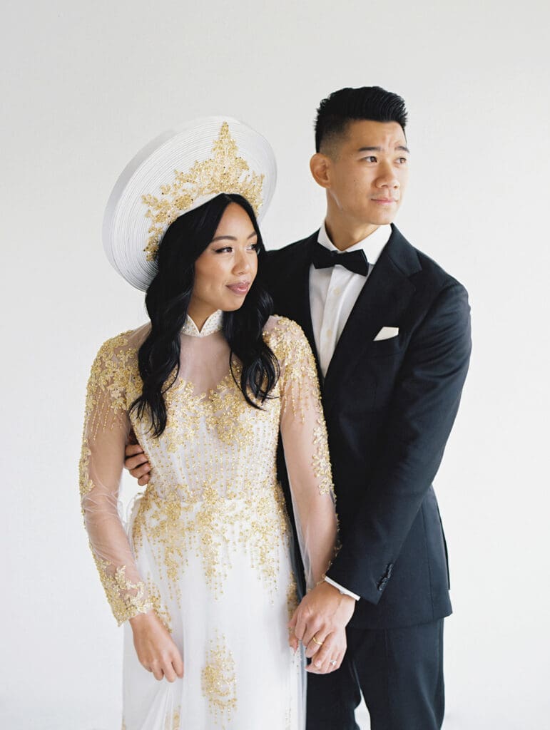 Bride and groom's studio portraits in South Bend, Indiana wearing traditional Vietnamese wedding attire. 