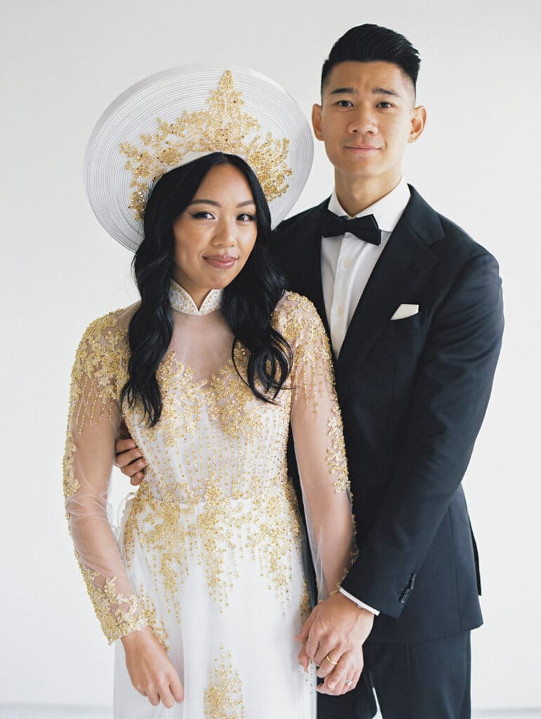 Bride and groom's studio portraits in South Bend, Indiana wearing traditional Vietnamese wedding attire. 