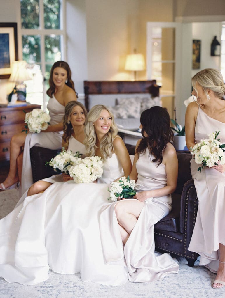 Bride and bridesmaids portraits in one of the master suites at Greencrest Manor wedding venue in Battle Creek, Michigan