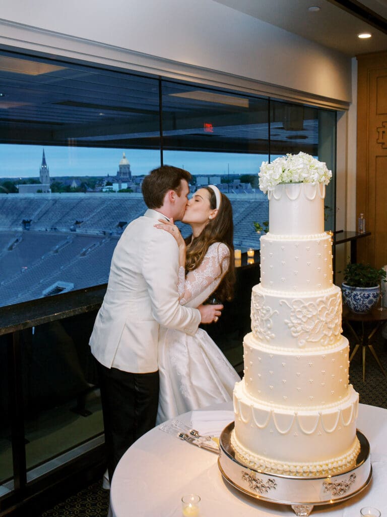 Bride and groom kissing after their cake cutting