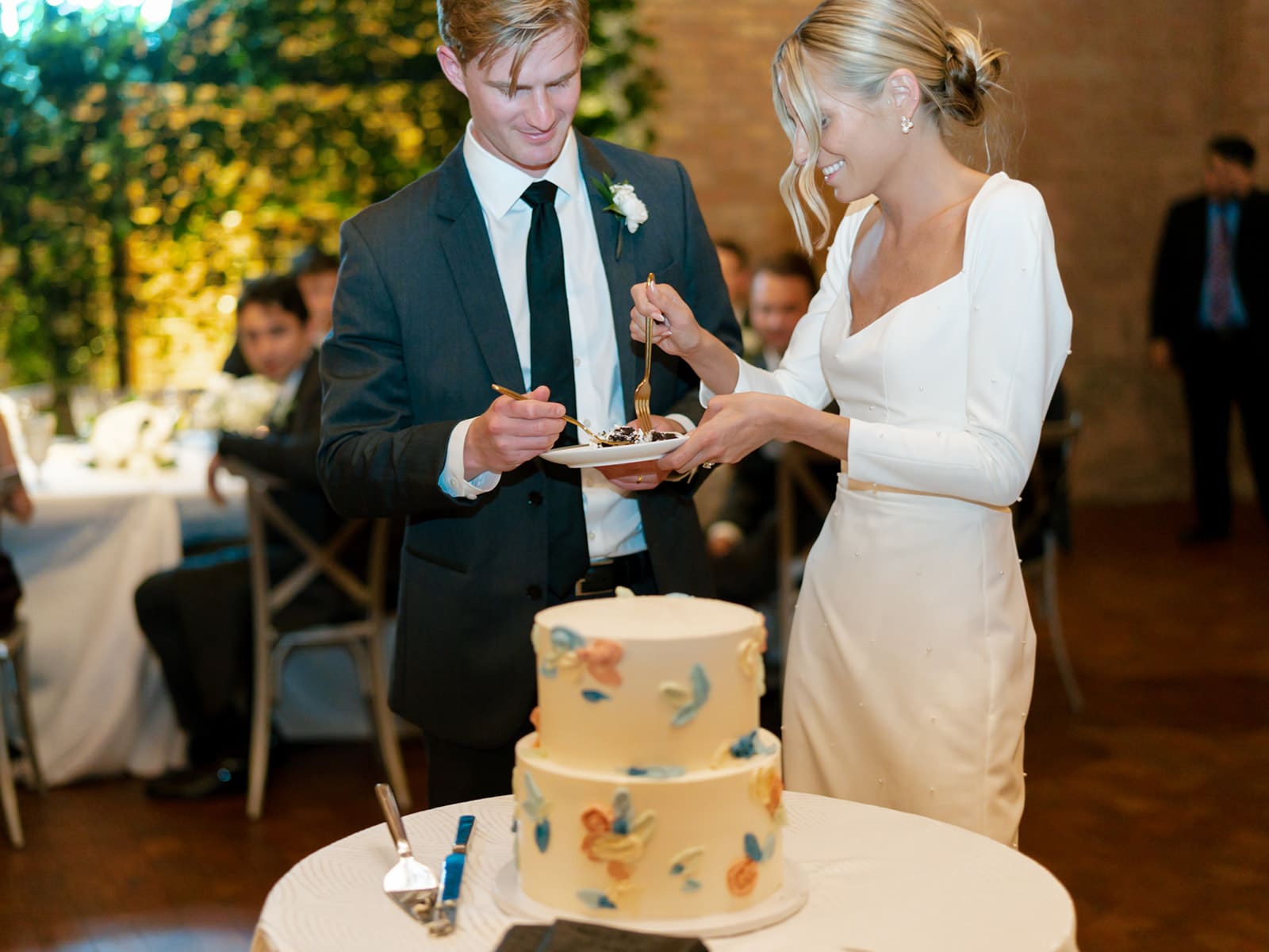 Bride and groom cutting into their wedding cake