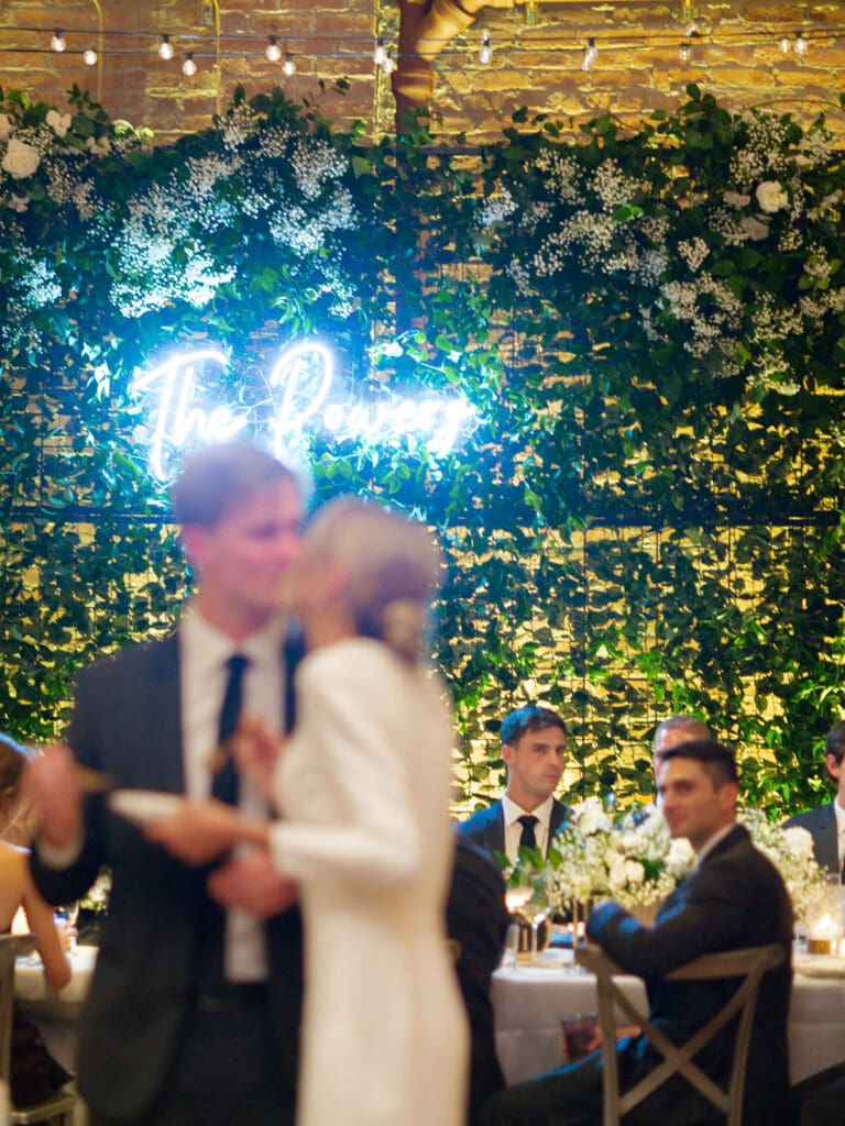 Out of focus photo of a bride and groom kissing after cake cutting