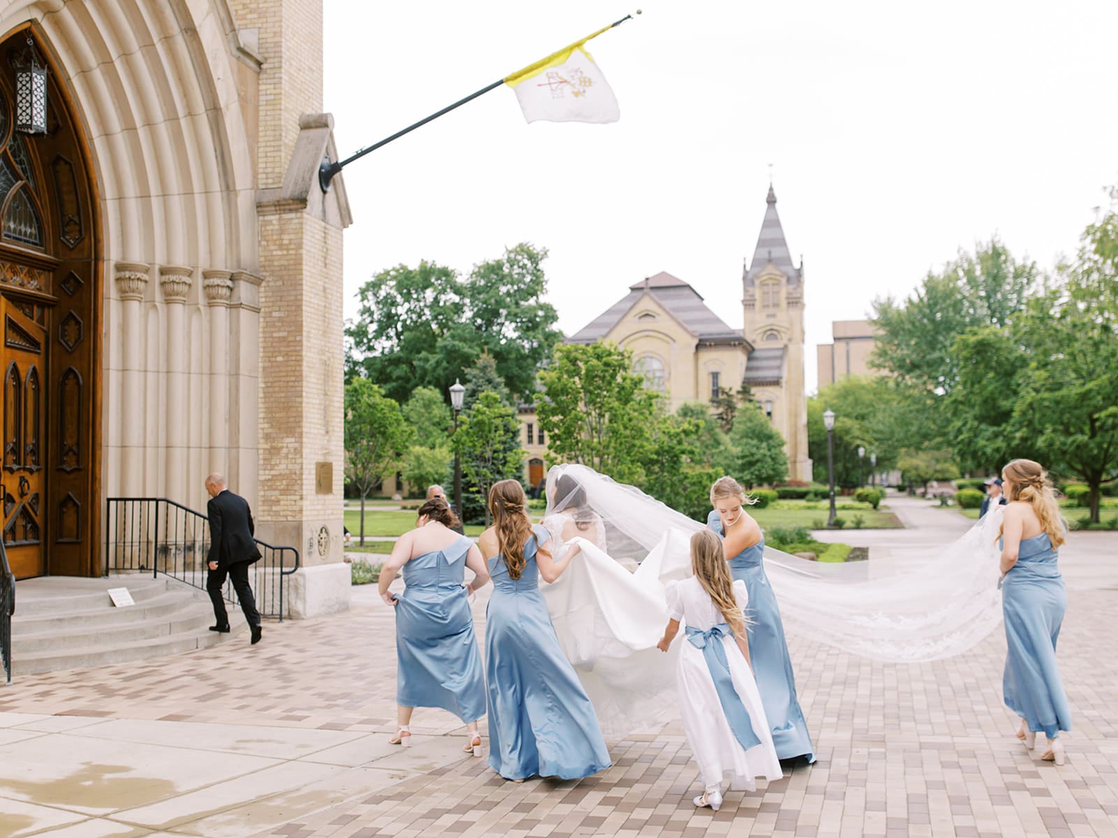 Bride walking into her Cathedral Basilica of The Sacred Heart Wedding ceremony at Notre Dame with her bridesmaids