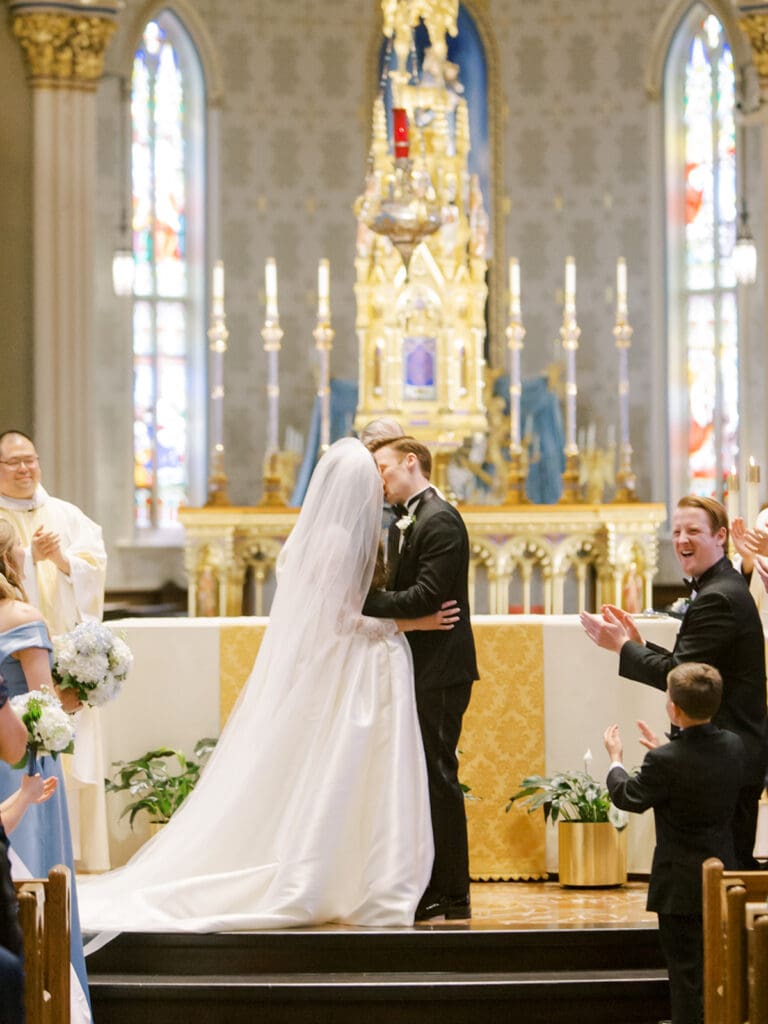 Bride and groom kissing during their A Cathedral Basilica of The Sacred Heart Wedding ceremony at Notre Dame
