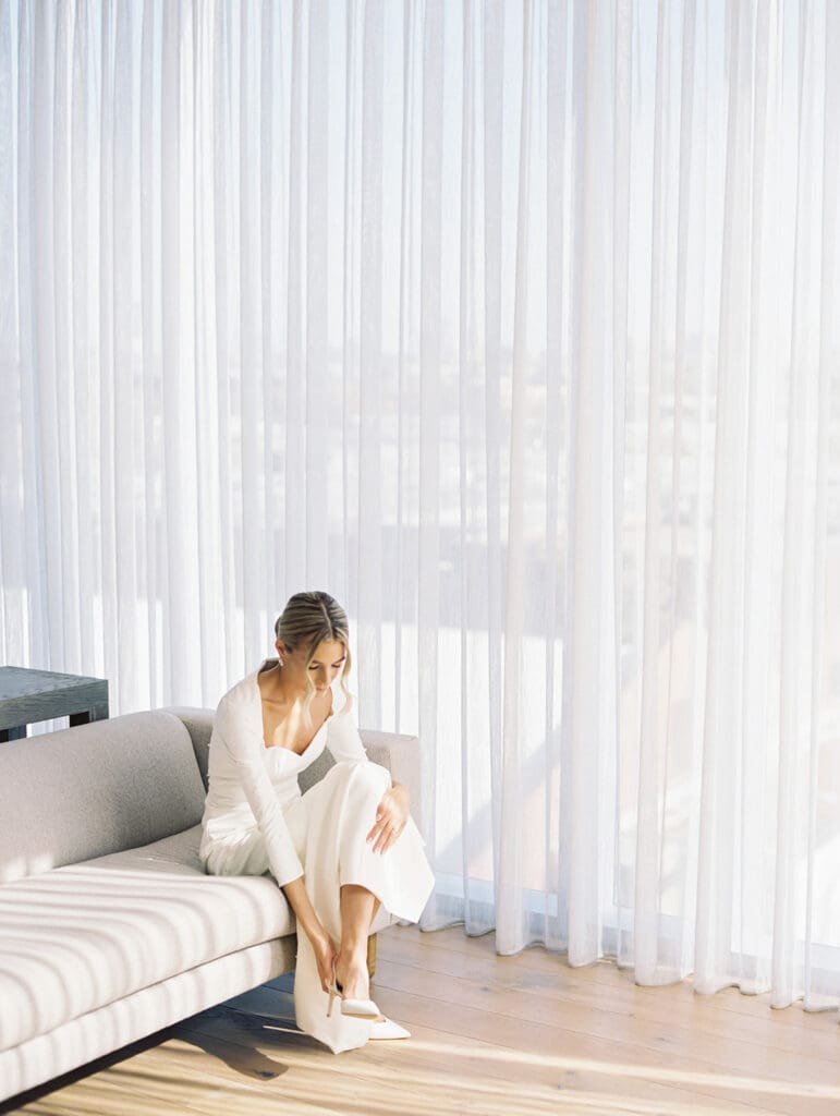 Bride putting her heels on