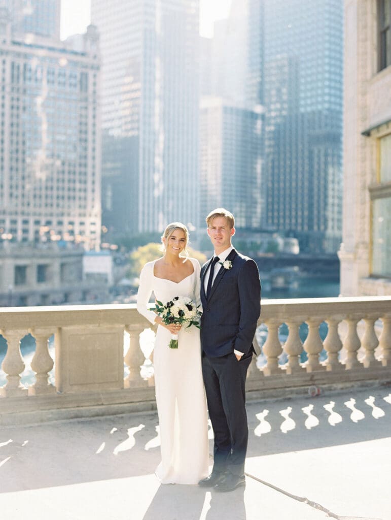 Bride and grooms fall downtown Chicago wedding portraits in front of The Wrigley Building