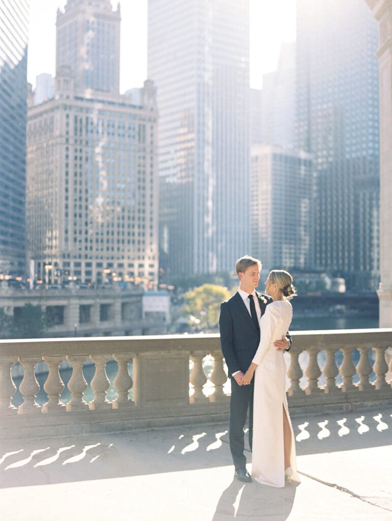 Bride and grooms fall downtown Chicago wedding portraits in front of The Wrigley Building