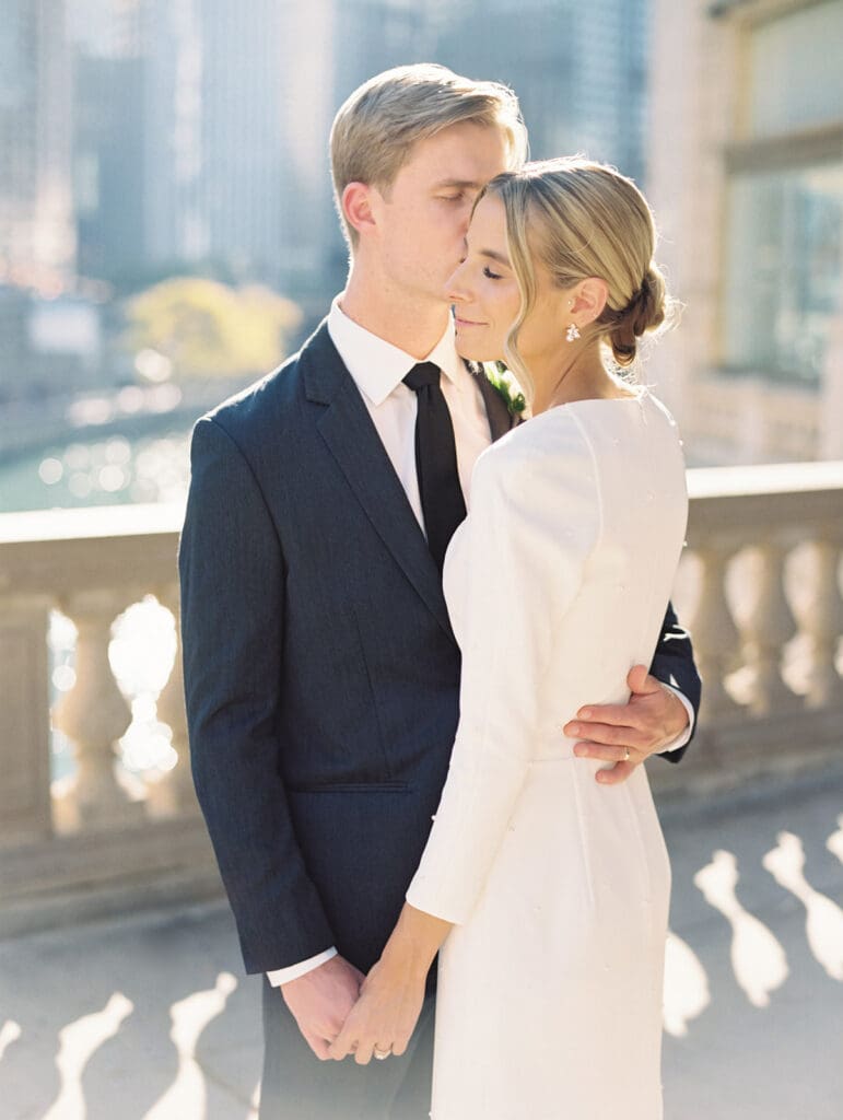 Bride and grooms fall downtown Chicago wedding portraits in front of The Wrigley Building