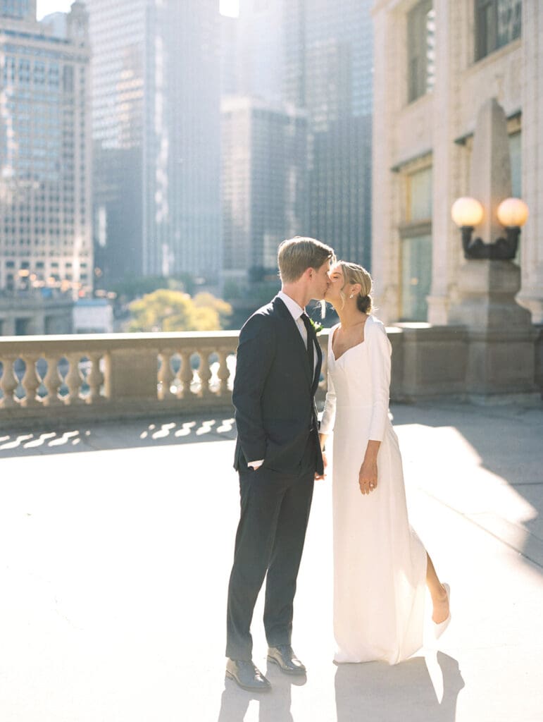 Bride and grooms fall downtown Chicago wedding portraits in front of The Wrigley Building