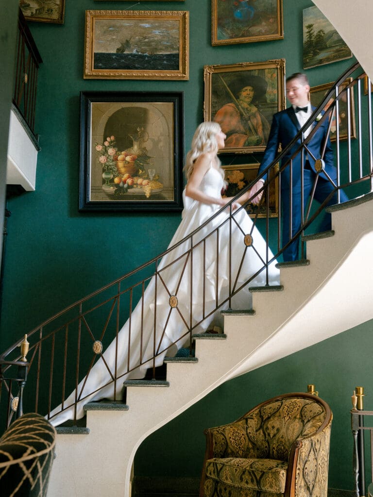 Bride and groom walking up the staircase at Greencrest Manor - Estate wedding venue in Michigan