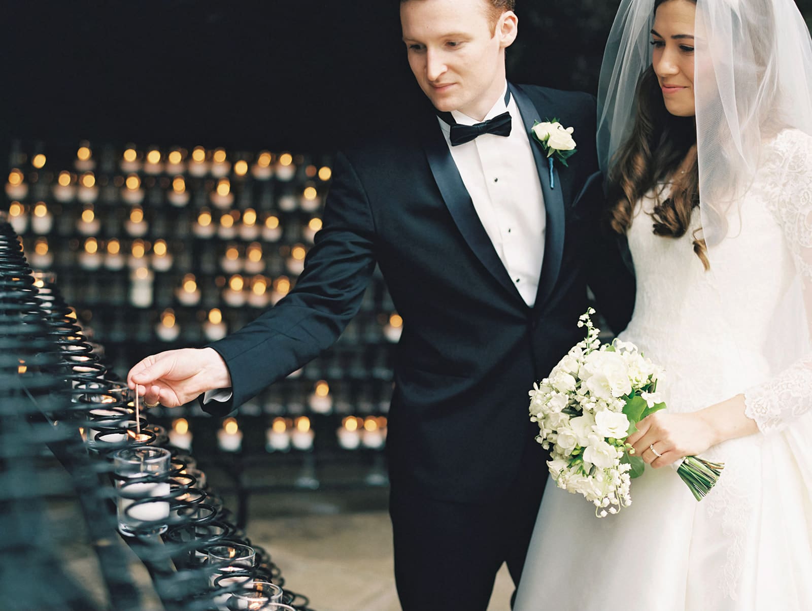 Bride and groom lighting a candle during their University of Notre Dame wedding