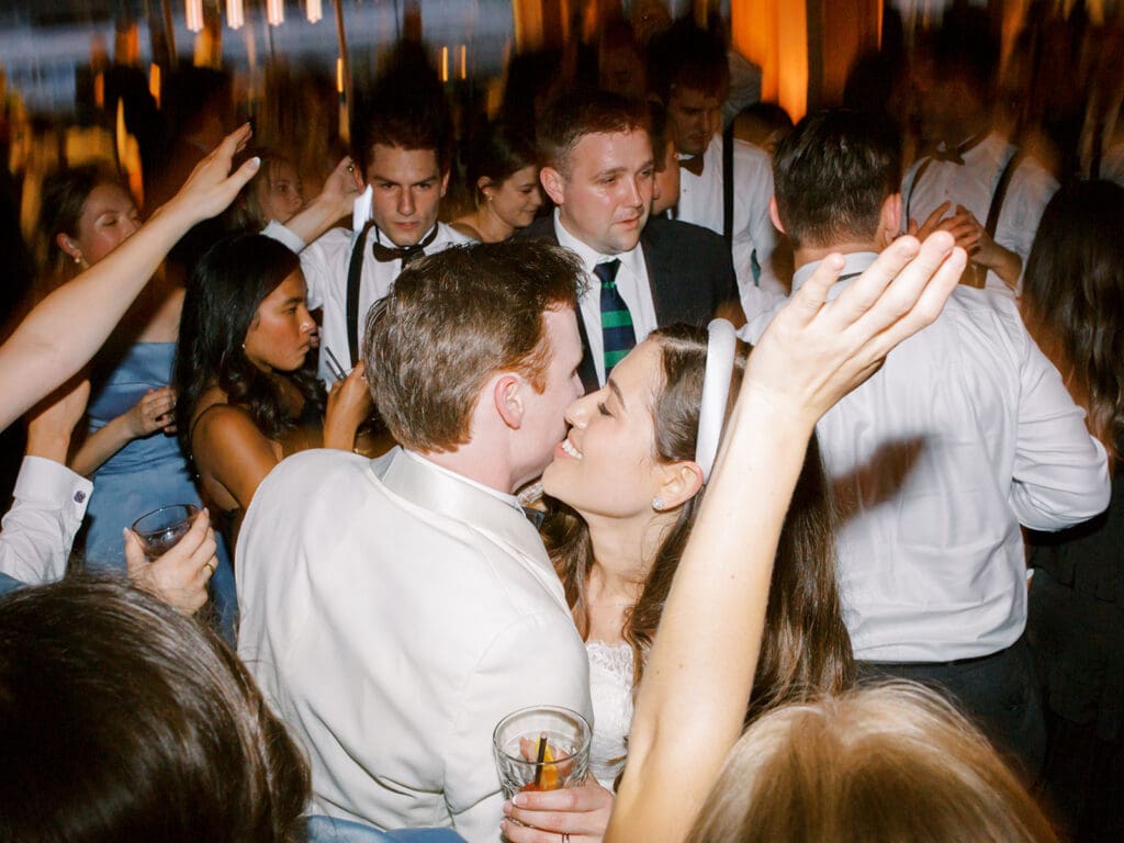 Bride and groom kissing during their wedding reception