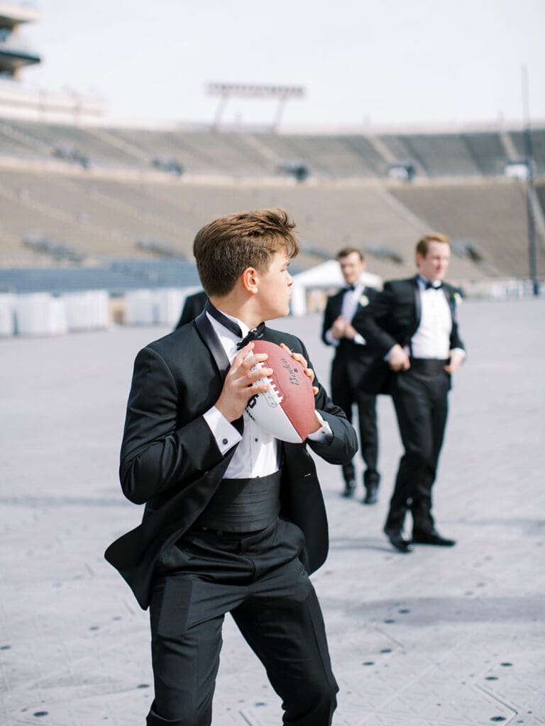 Fun groom and groomsmen football style photos from a University of Notre Dame wedding in Indiana